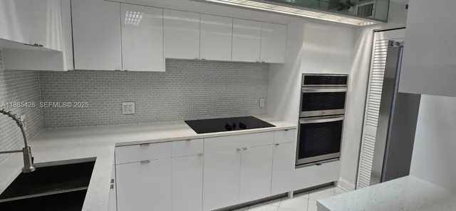 a view of a kitchen with storage and utility room