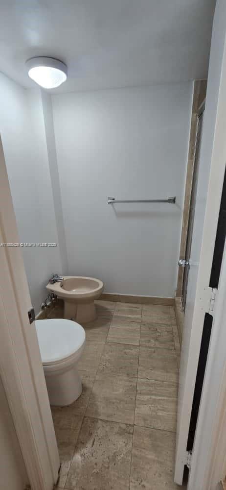 2843 South Bayshore Drive, Unit 3A Miami, FL 33133 - Photo 33 of 43 a bathroom with a granite countertop toilet and a sink