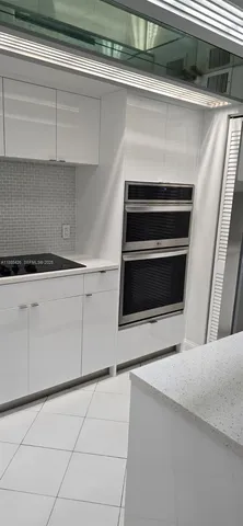 a kitchen with appliances and cabinets