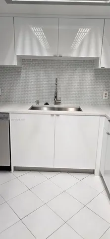 a kitchen with a cabinets and white appliances