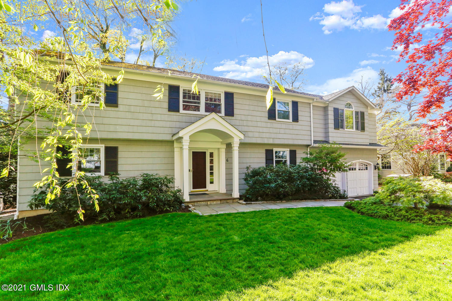 a front view of a house with garden