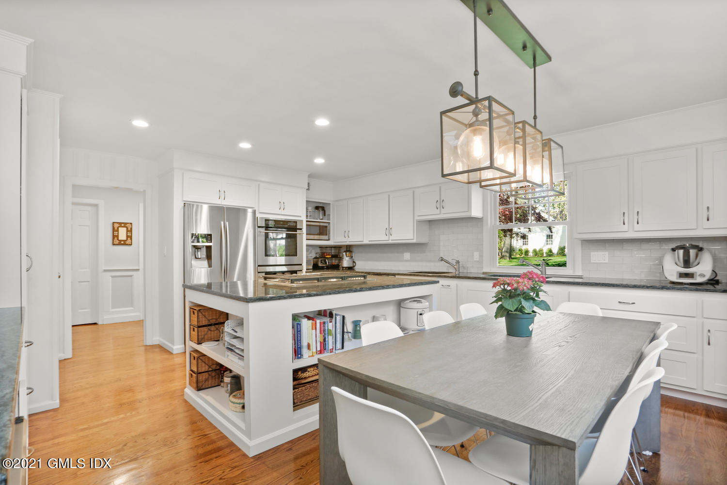 6 Palmer Terrace Riverside, CT 06878 - Photo 7 of 24 a kitchen with stainless steel appliances granite countertop a sink a stove a refrigerator cabinets and living room view