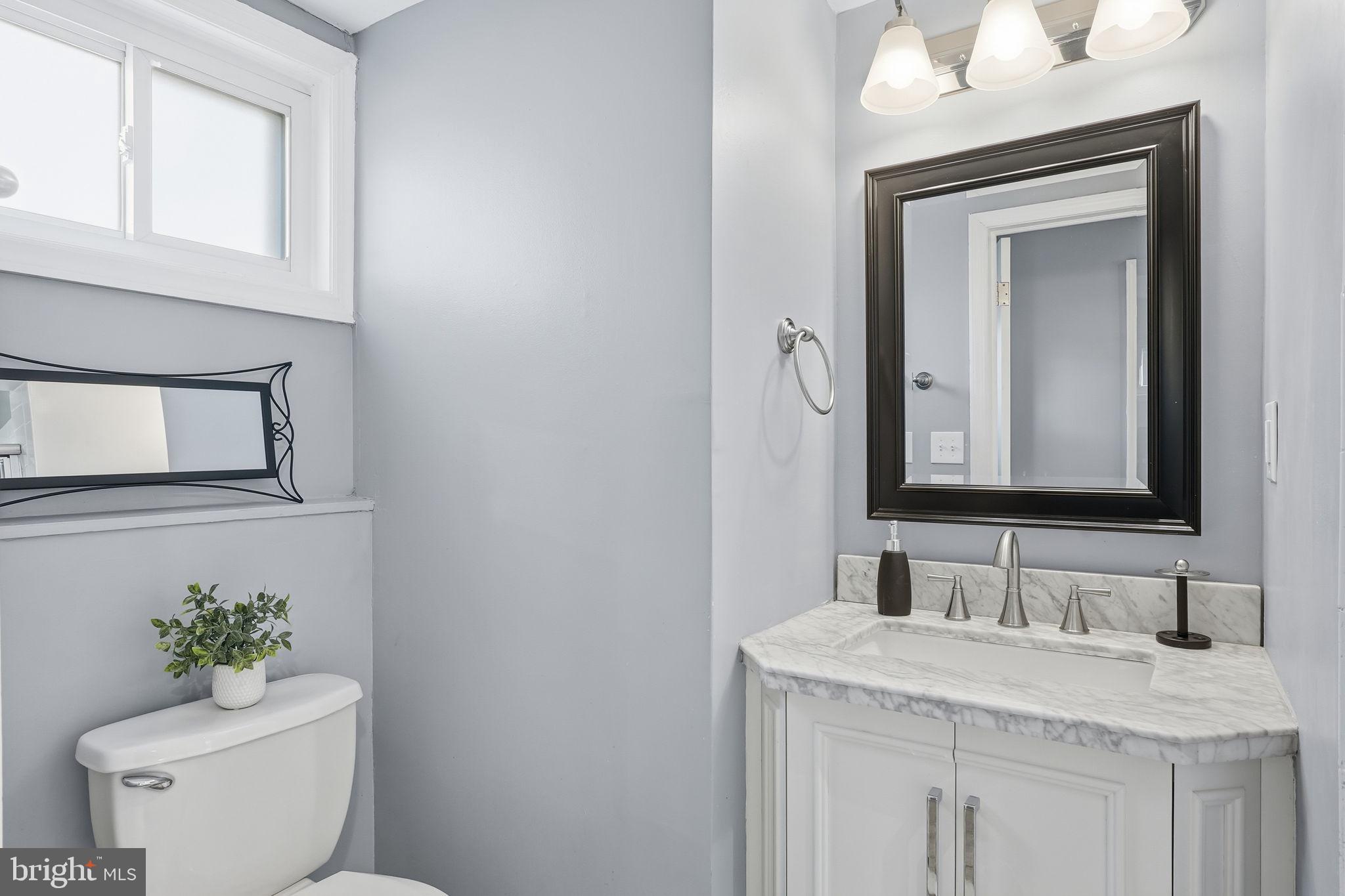 19 Williams Drive Annapolis, MD 21401 - Photo 16 of 45 a bathroom with a granite countertop sink vanity mirror and toilet