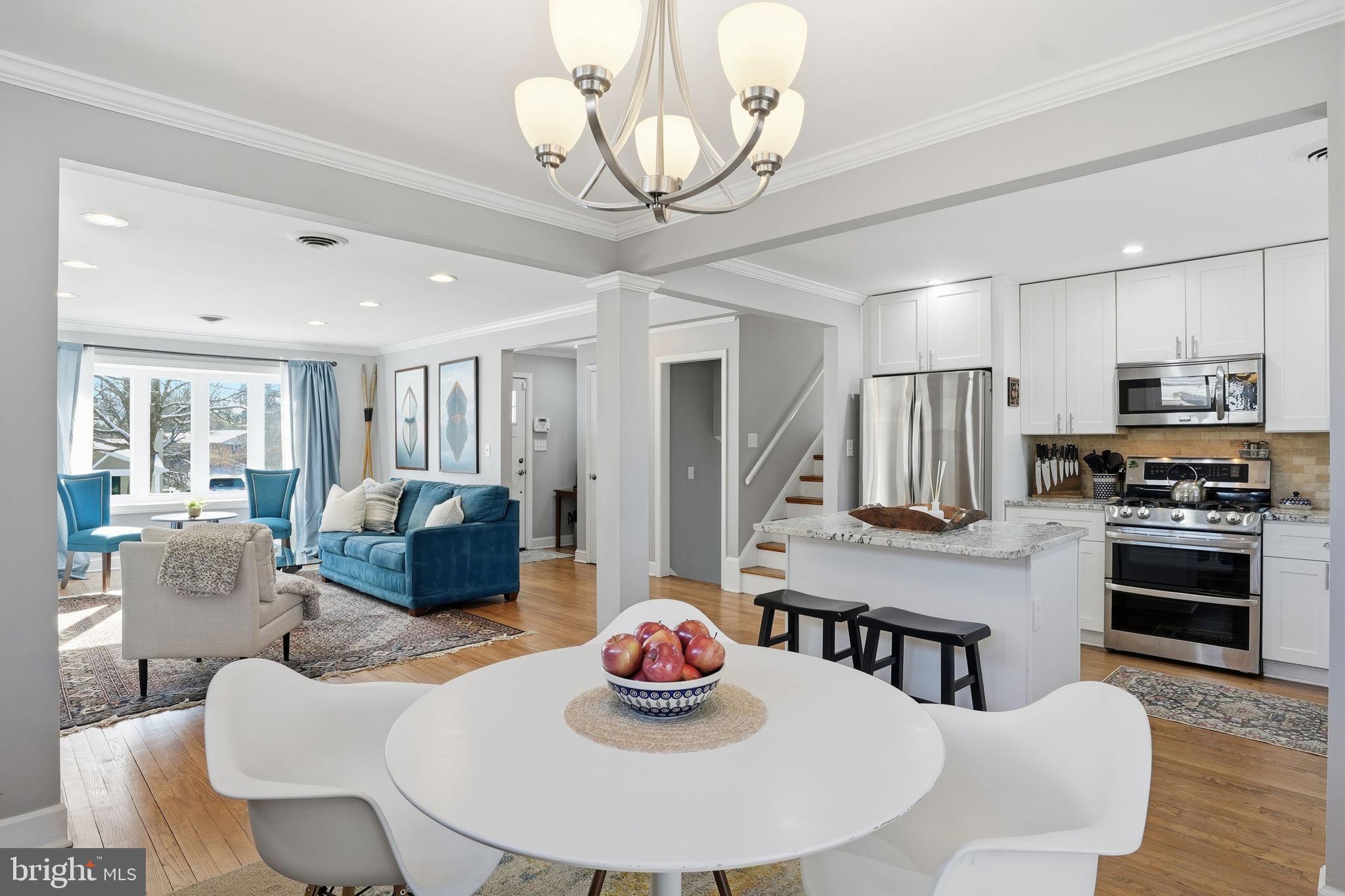 19 Williams Drive Annapolis, MD 21401 - Photo 19 of 45 a kitchen with stainless steel appliances granite countertop a dining table chairs stove and refrigerator