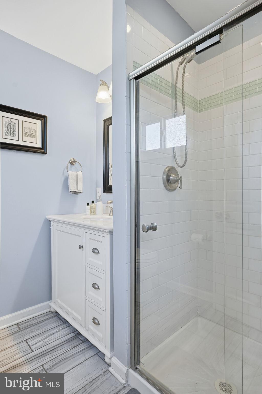 19 Williams Drive Annapolis, MD 21401 - Photo 23 of 45 a bathroom with a shower sink and mirror