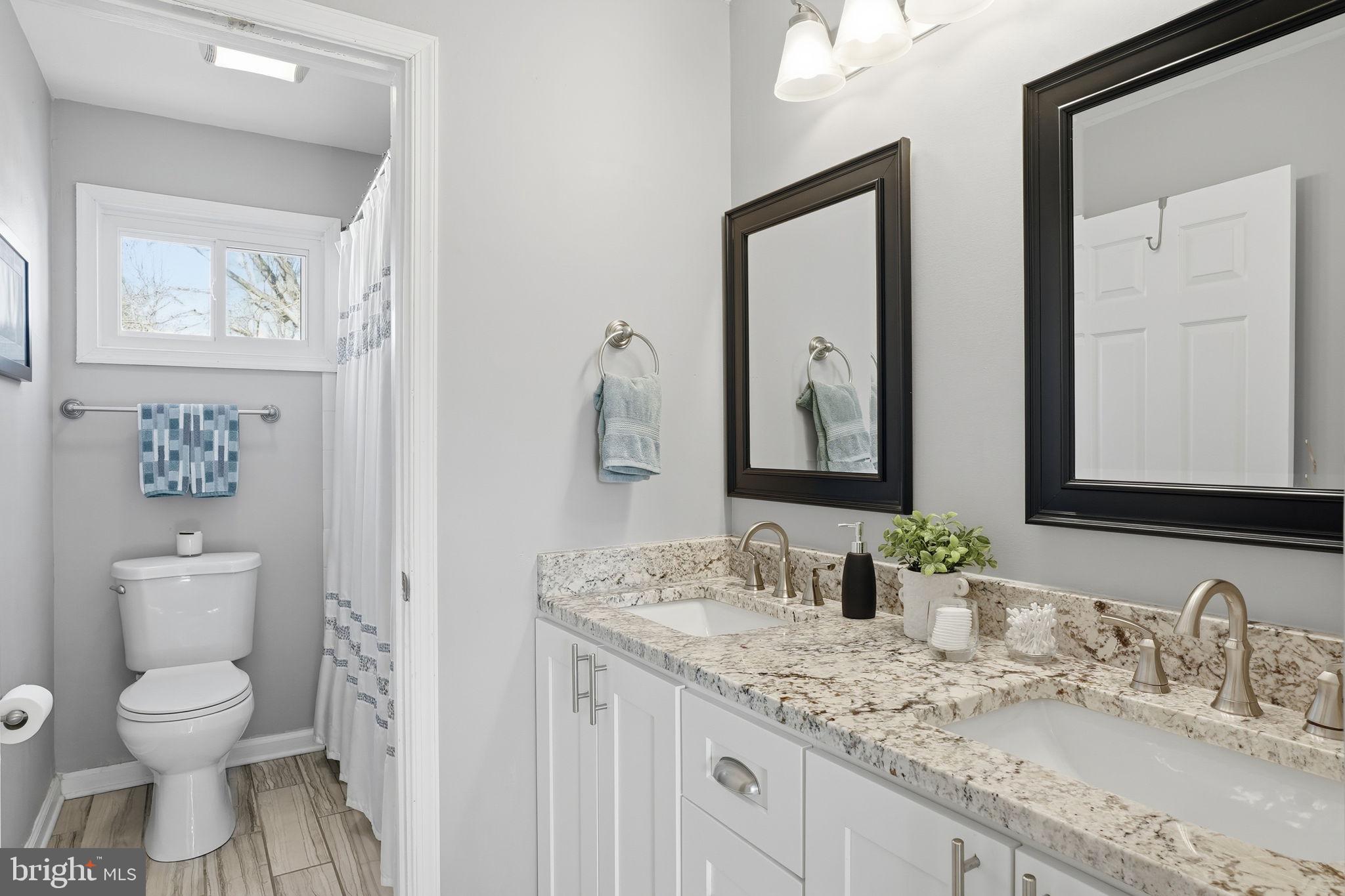 19 Williams Drive Annapolis, MD 21401 - Photo 26 of 45 a bathroom with a granite countertop toilet sink and mirror