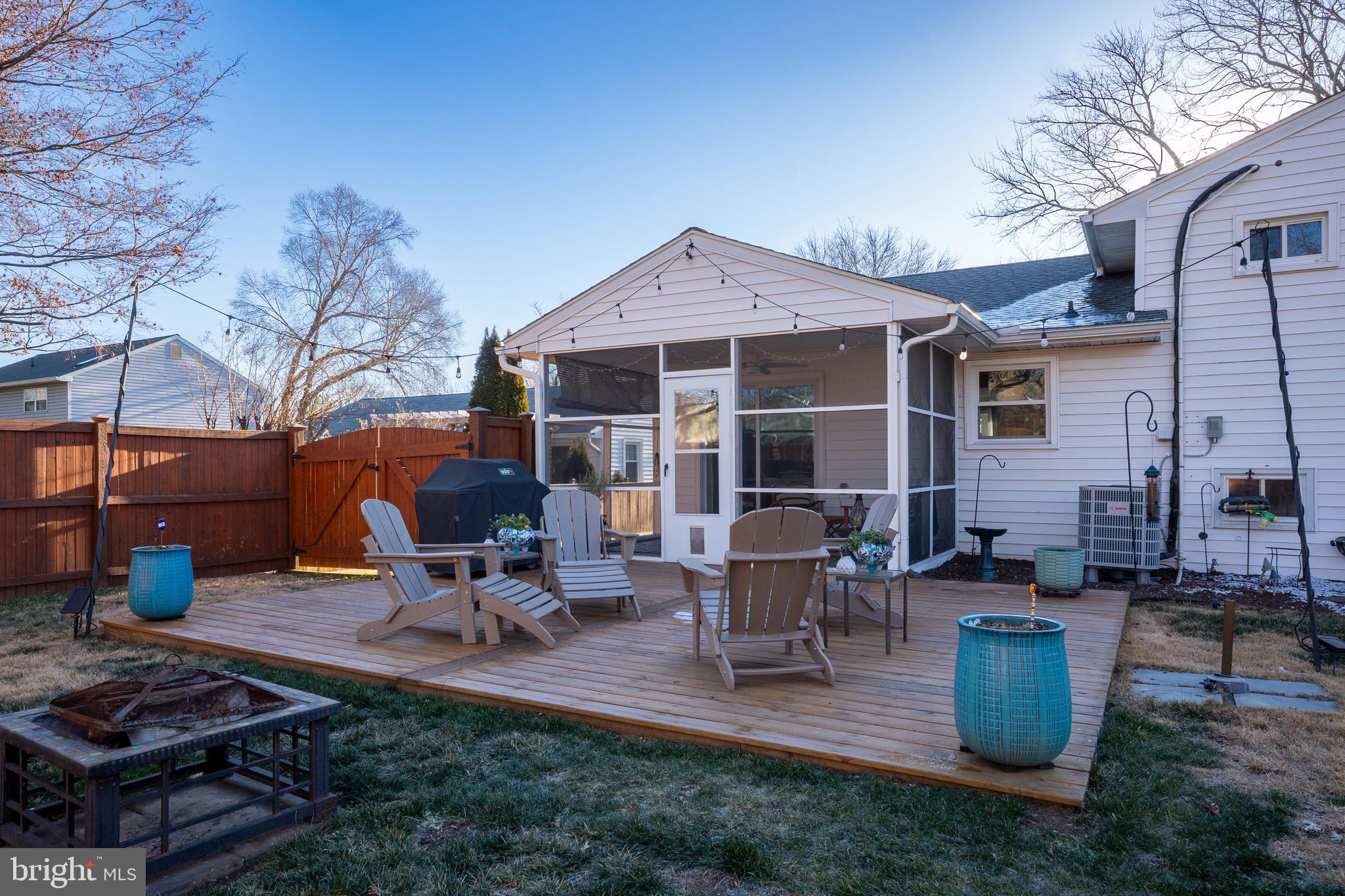 19 Williams Drive Annapolis, MD 21401 - Photo 29 of 45 a view of a patio with table and chairs barbeque potted plants and large tree