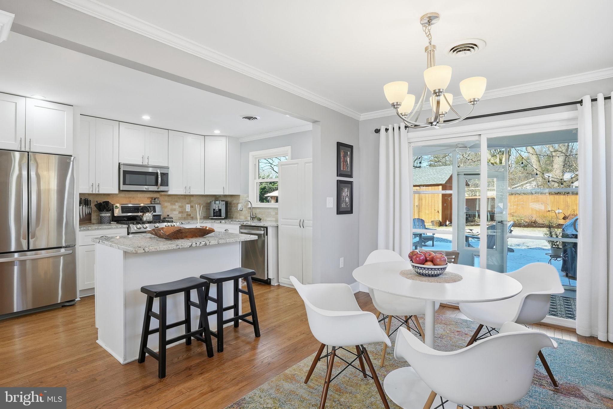 19 Williams Drive Annapolis, MD 21401 - Photo 10 of 45 a kitchen with a dining table chairs refrigerator and cabinets