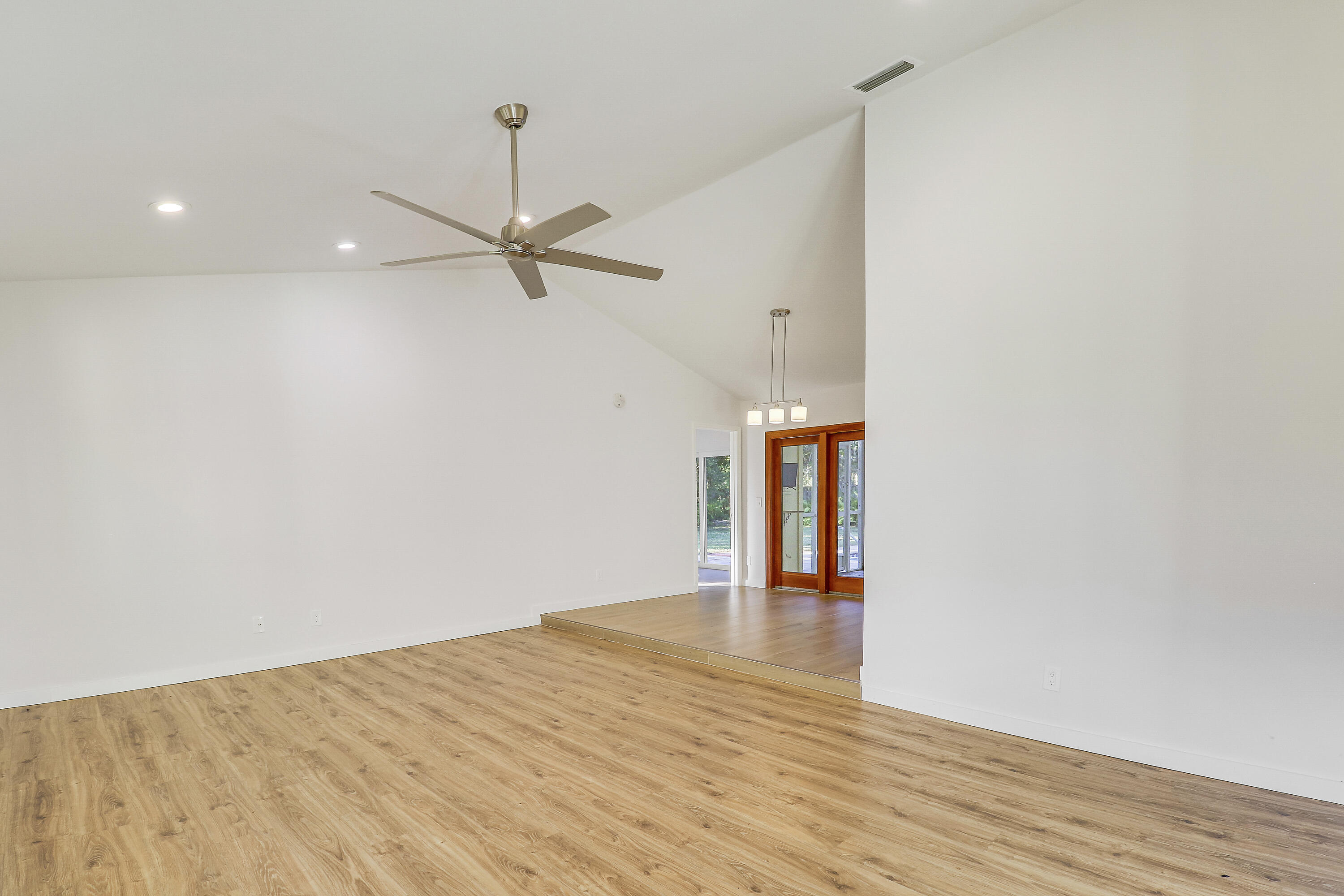 5775 Set-N-Sun Place Jupiter, FL 33458 - Photo 18 of 54 a view of empty room with wooden floor and fan