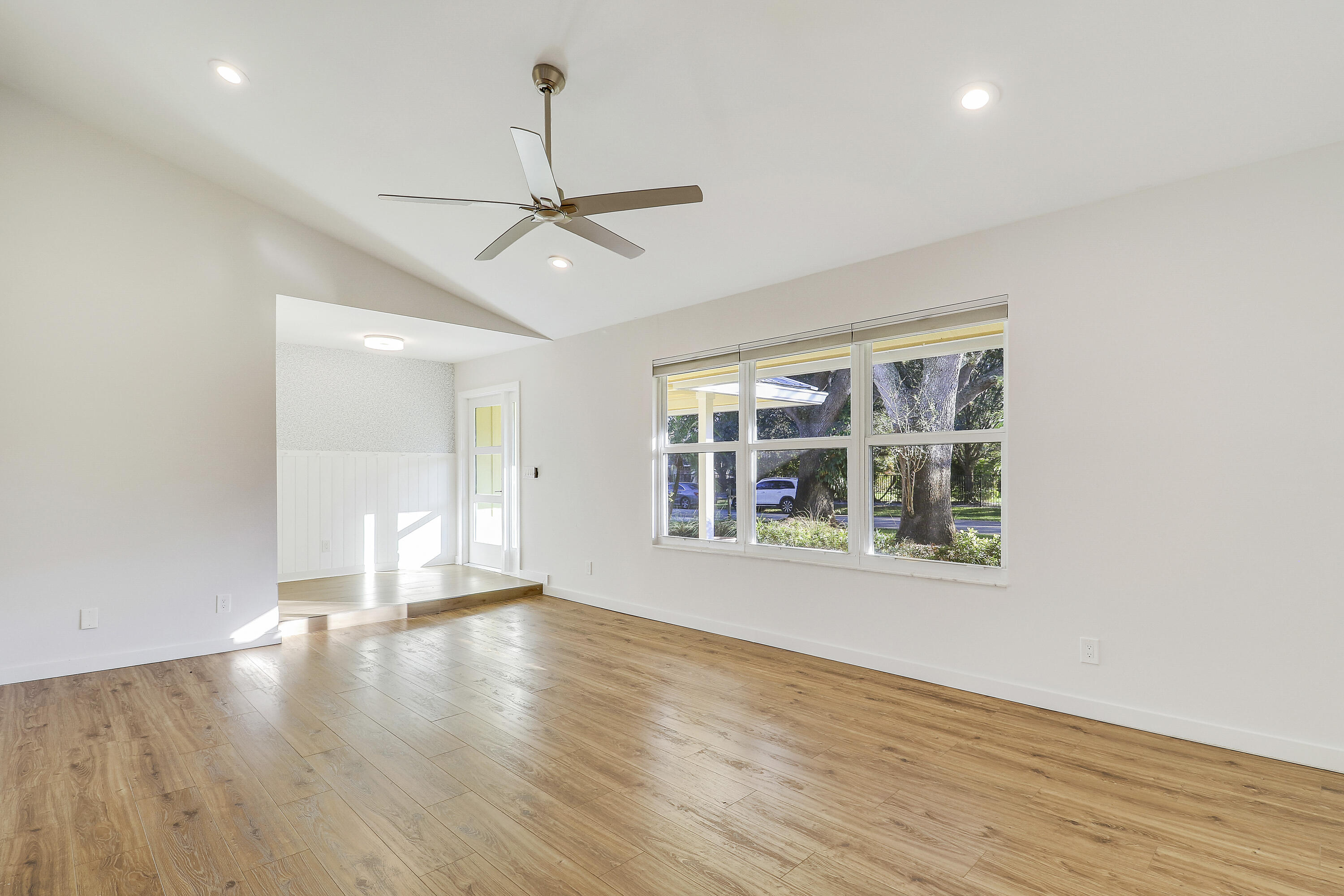 5775 Set-N-Sun Place Jupiter, FL 33458 - Photo 21 of 54 a view of an empty room with wooden floor and a window