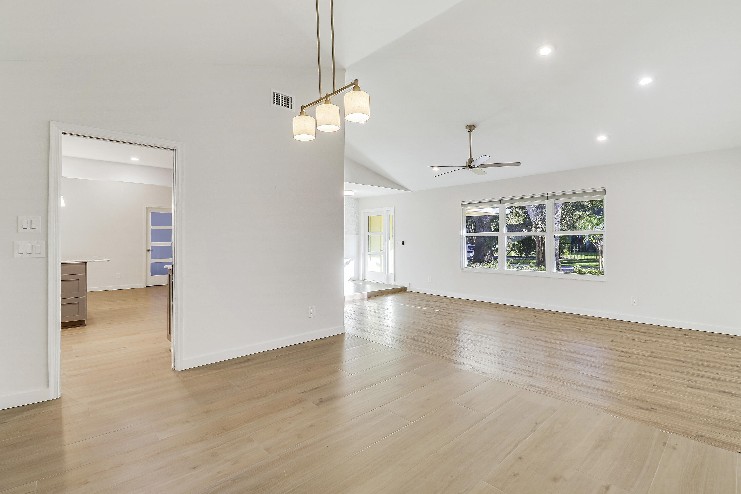 5775 Set-N-Sun Place Jupiter, FL 33458 - Photo 23 of 54 a view of a livingroom with wooden floor and a ceiling fan