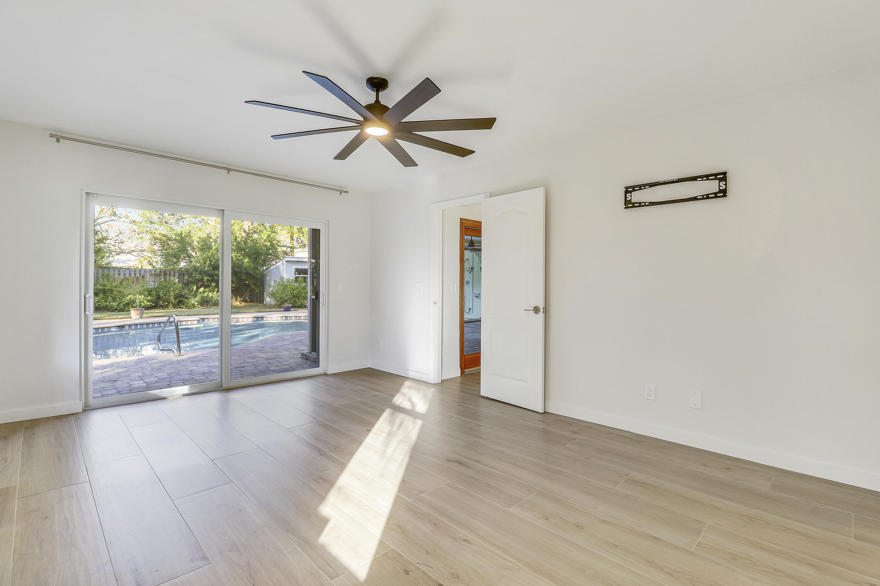 5775 Set-N-Sun Place Jupiter, FL 33458 - Photo 25 of 54 a view of a livingroom with wooden floor and a ceiling fan