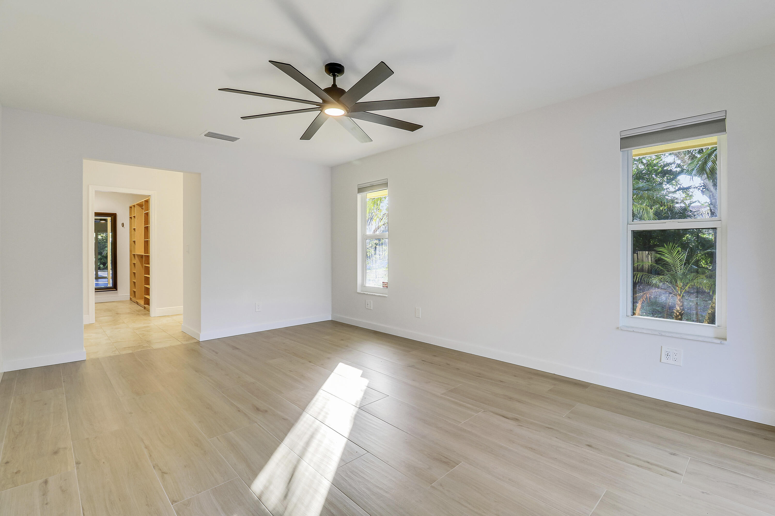 5775 Set-N-Sun Place Jupiter, FL 33458 - Photo 26 of 54 a view of a big room with wooden floor closet and windows