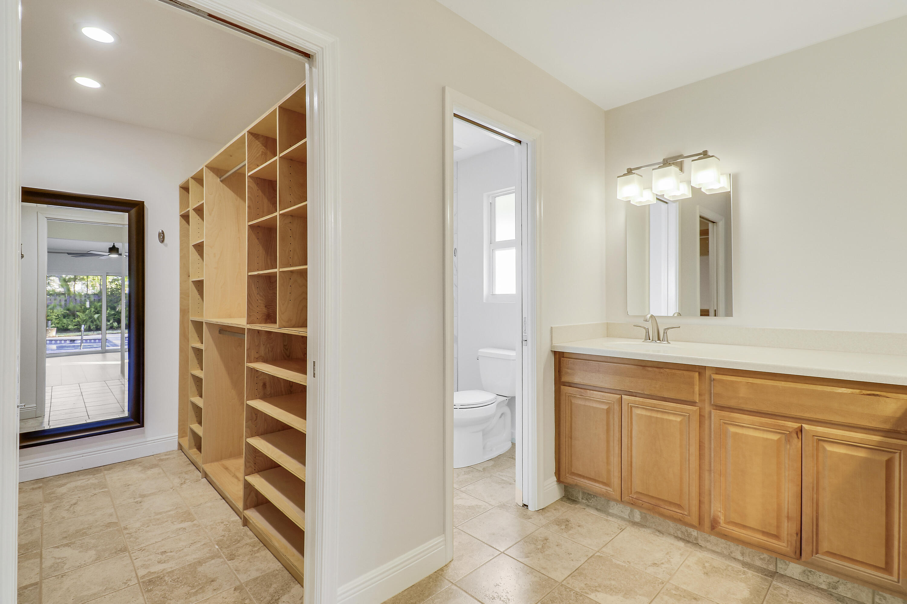 5775 Set-N-Sun Place Jupiter, FL 33458 - Photo 27 of 54 a view of a bathroom with a sink and a mirror