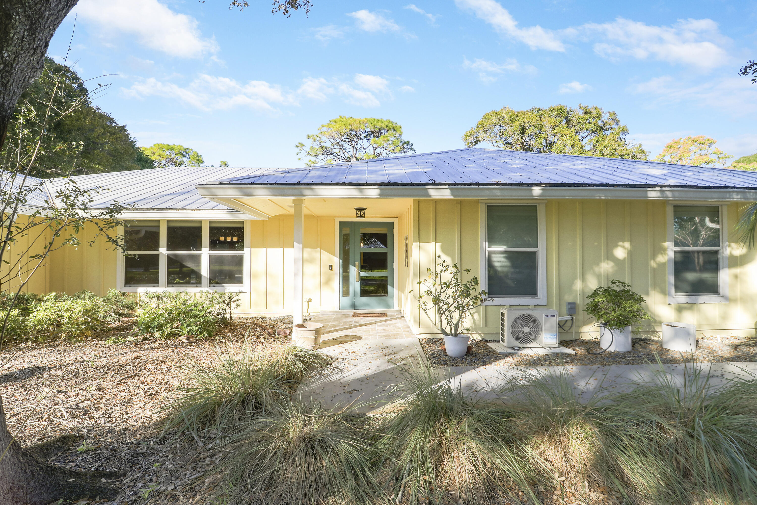 5775 Set-N-Sun Place Jupiter, FL 33458 - Photo 3 of 54 a front view of a house with a yard