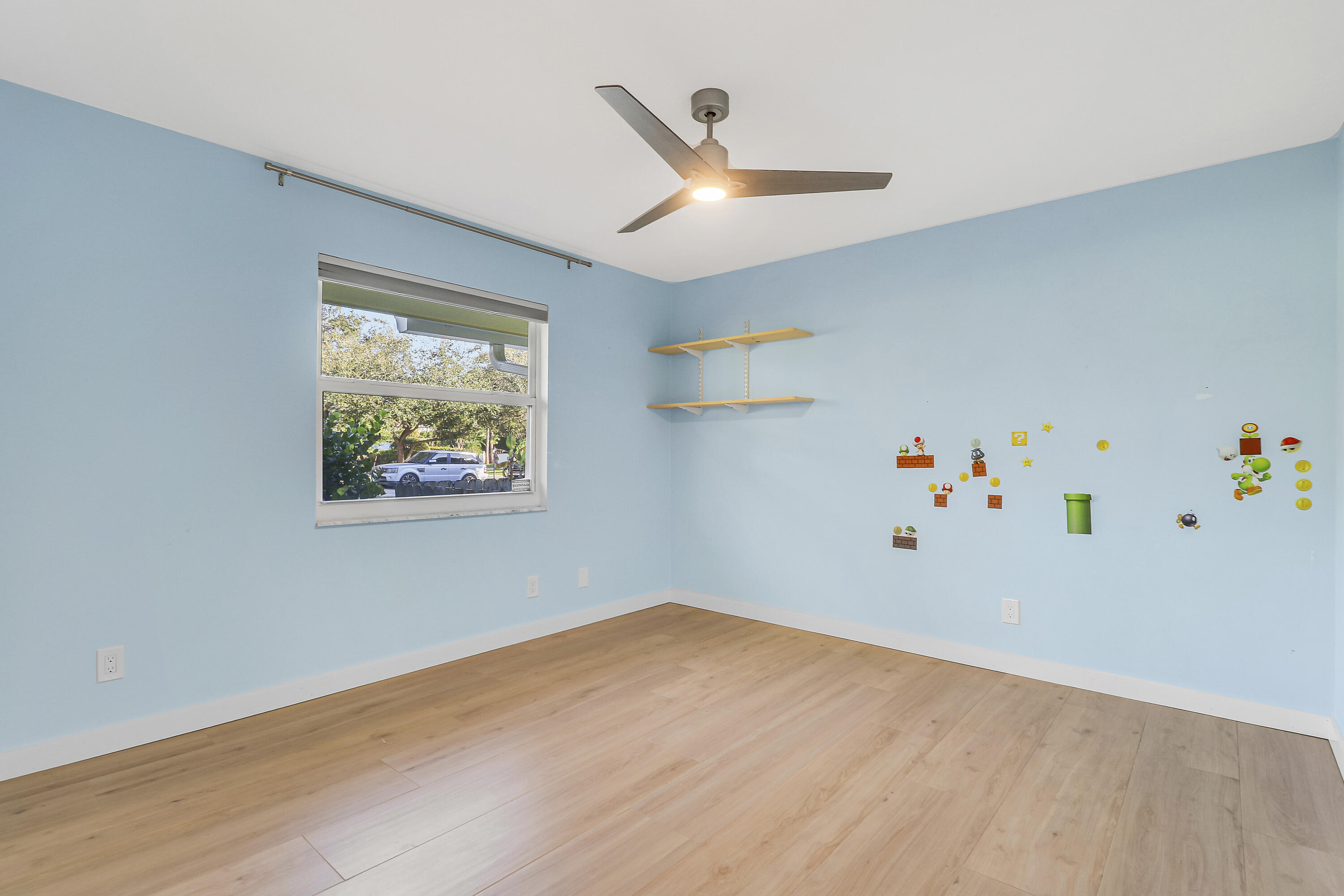 5775 Set-N-Sun Place Jupiter, FL 33458 - Photo 34 of 54 a room with a wooden floor and a ceiling fan