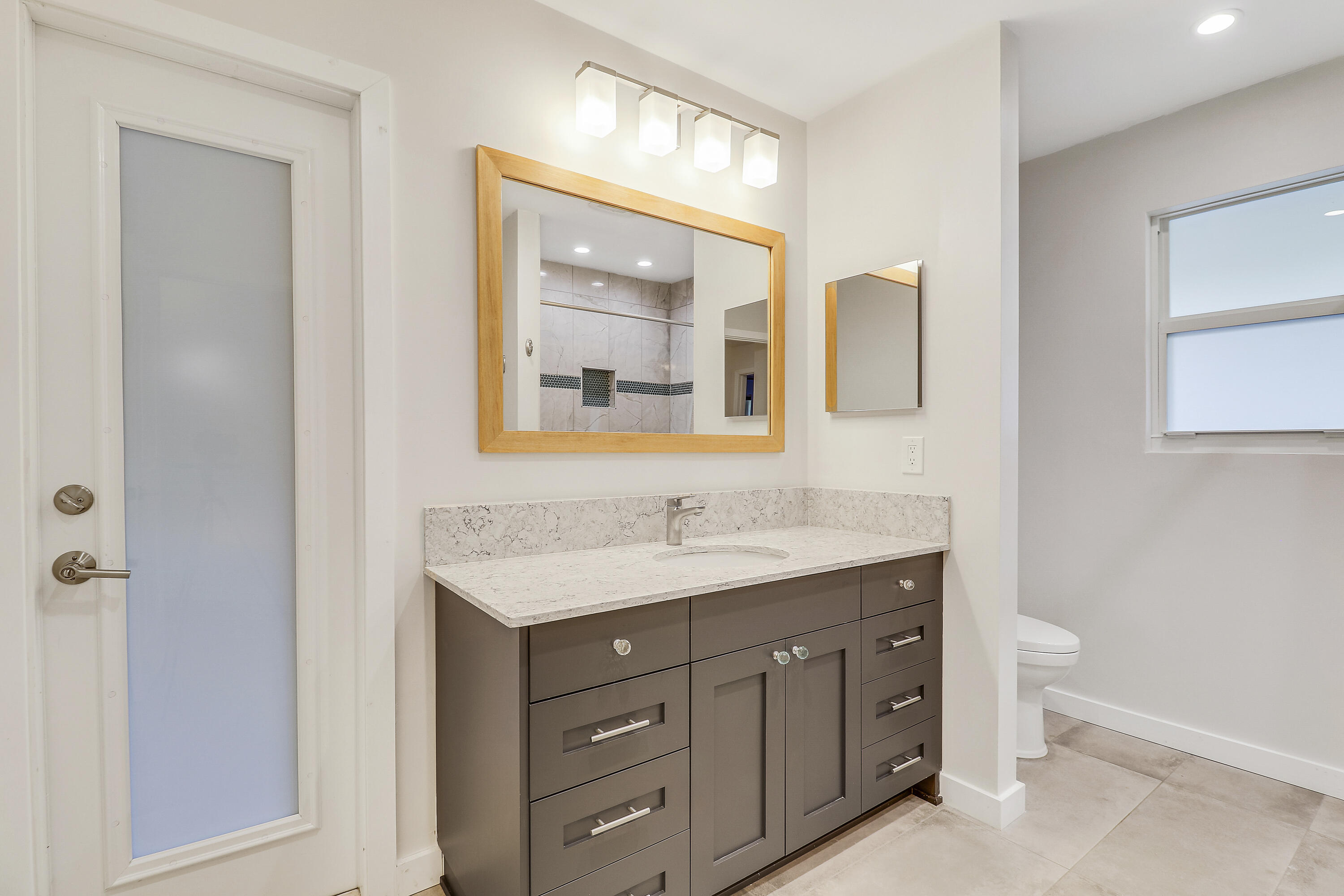 5775 Set-N-Sun Place Jupiter, FL 33458 - Photo 35 of 54 a bathroom with a granite countertop sink toilet and mirror