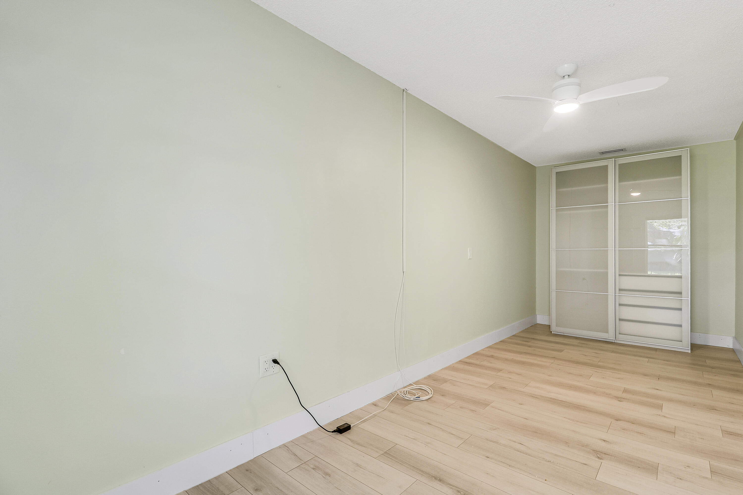 5775 Set-N-Sun Place Jupiter, FL 33458 - Photo 40 of 54 a view of empty room with wooden floor
