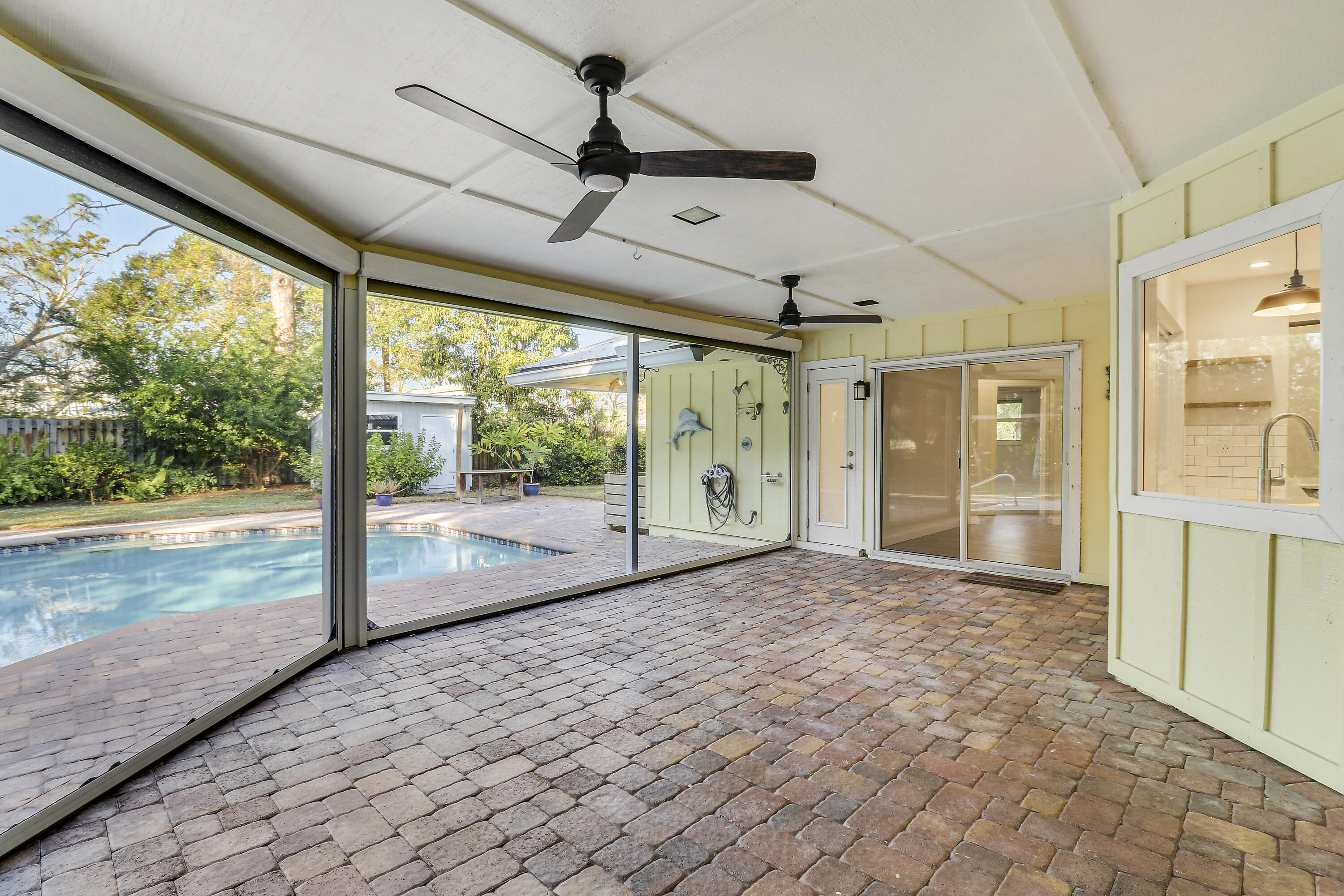 5775 Set-N-Sun Place Jupiter, FL 33458 - Photo 42 of 54 a view of a porch with wooden floor and front door