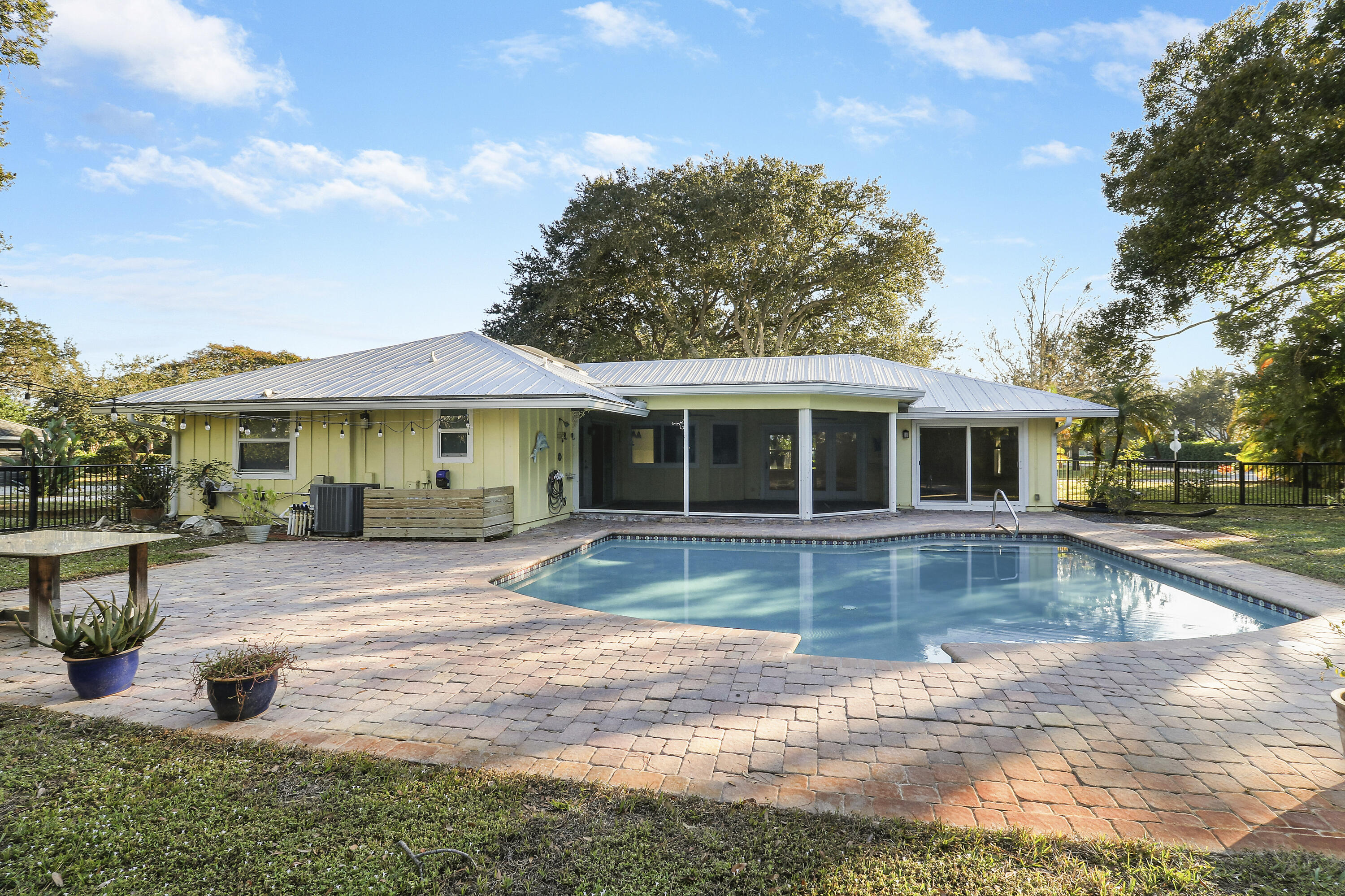 5775 Set-N-Sun Place Jupiter, FL 33458 - Photo 43 of 54 a view of a house with swimming pool and sitting area