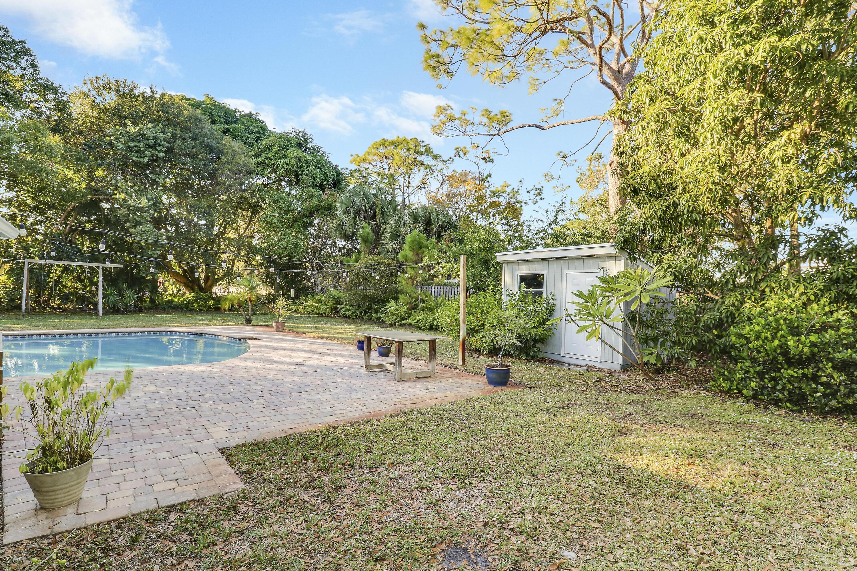 5775 Set-N-Sun Place Jupiter, FL 33458 - Photo 48 of 54 a view of a house with a yard