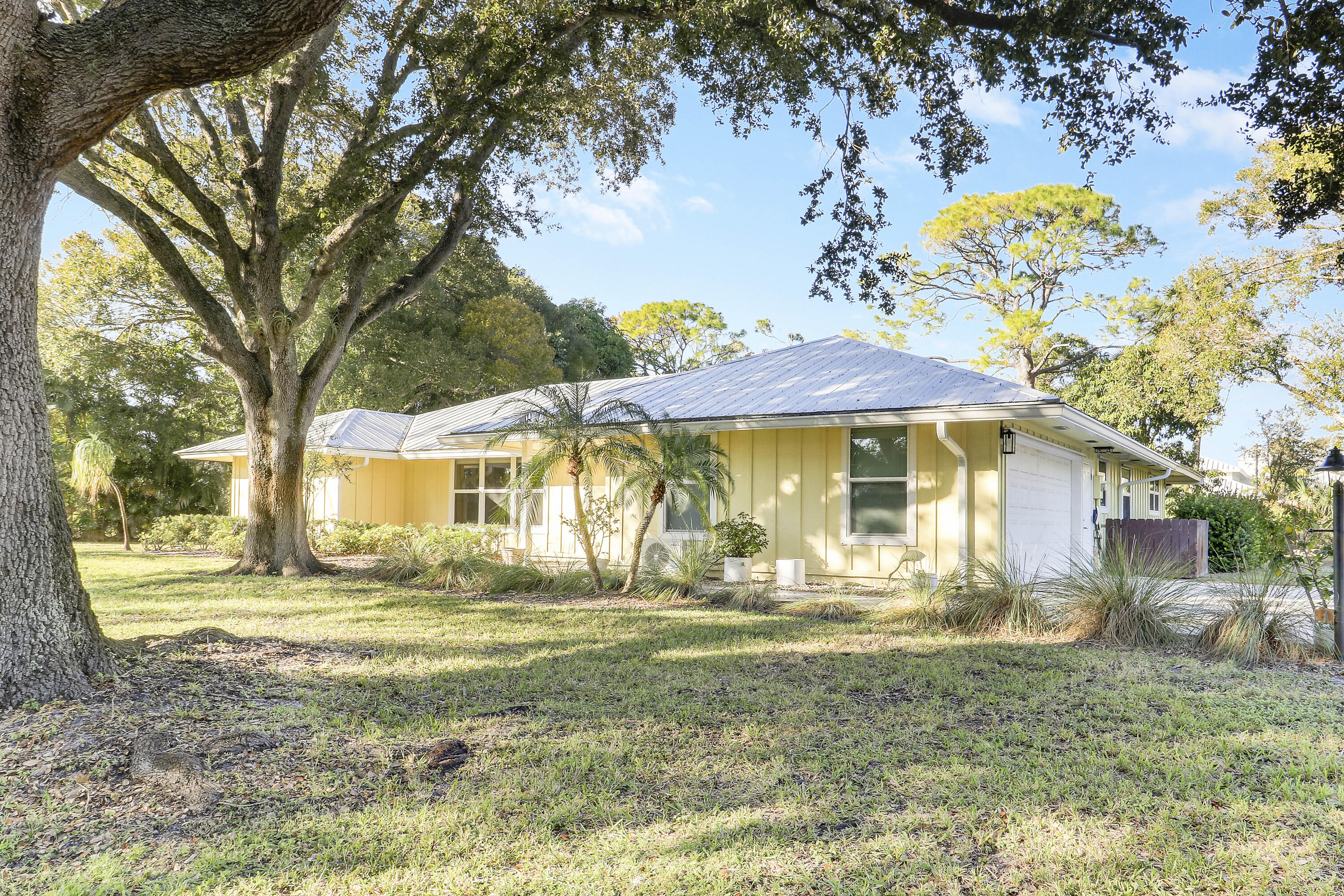 5775 Set-N-Sun Place Jupiter, FL 33458 - Photo 5 of 54 a front view of a house with a yard