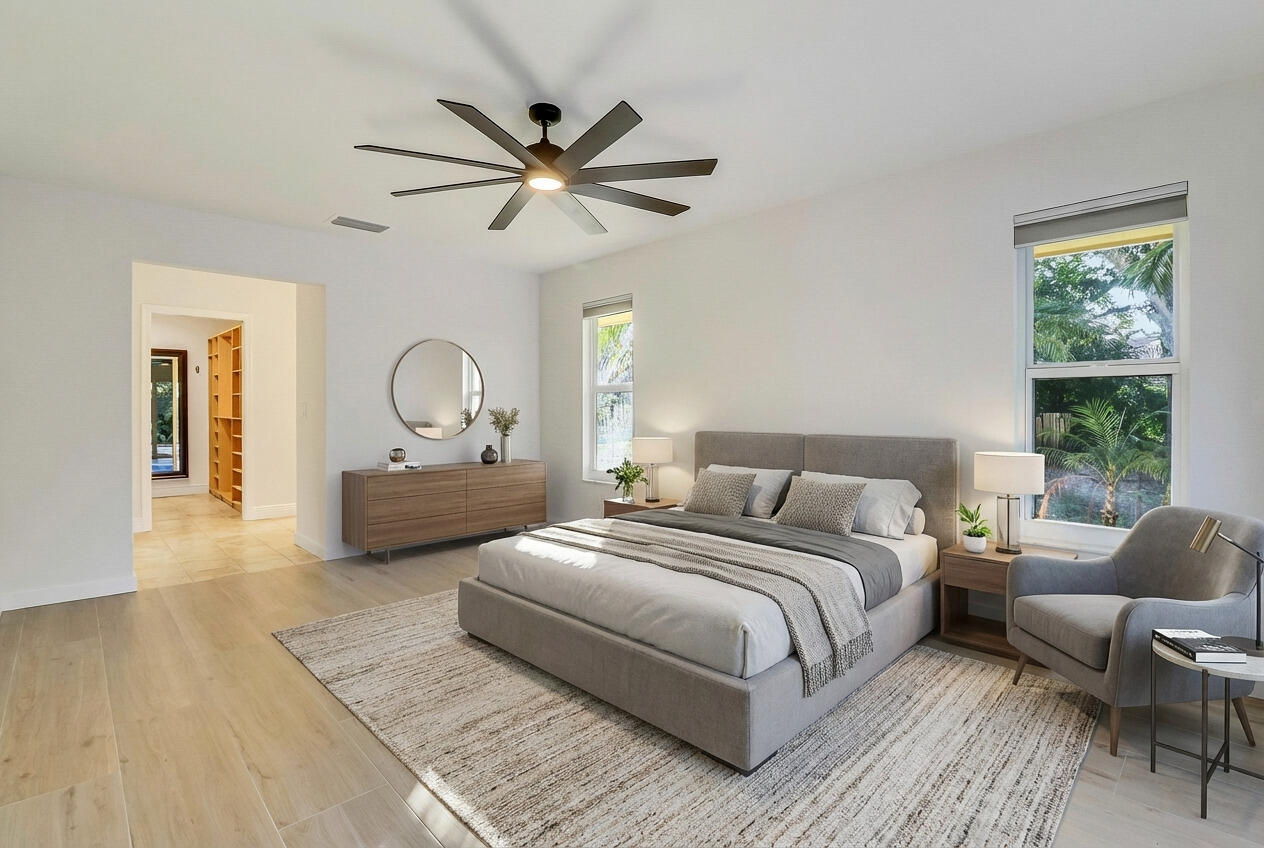 5775 Set-N-Sun Place Jupiter, FL 33458 - Photo 54 of 54 a bedroom with a large bed and a chandelier