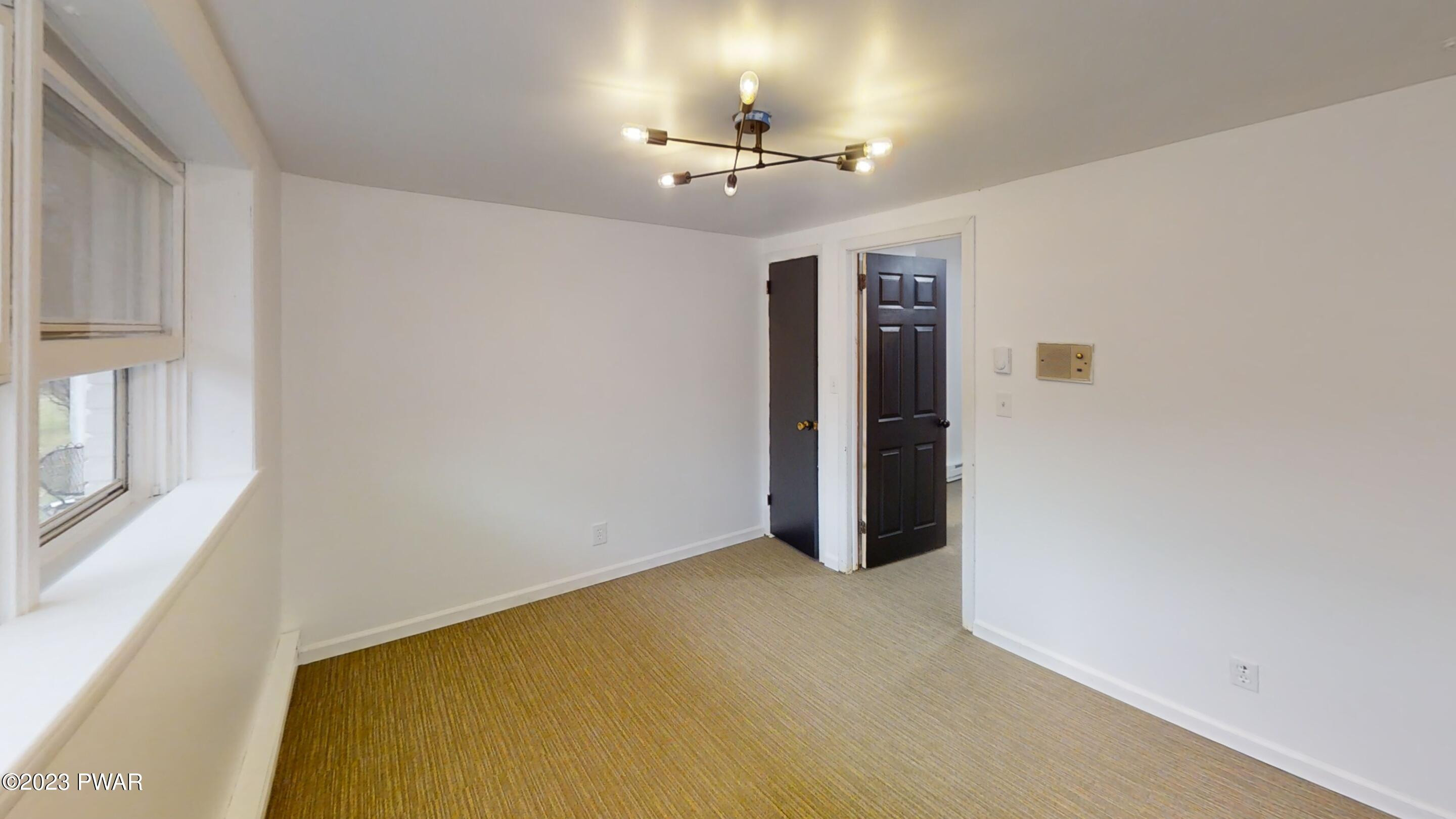 466 Old Gravity Road Lake Ariel, PA 18436 - Photo 24 of 35 a view of an empty room with a chandelier