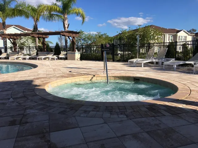 a view of a swimming pool with a patio