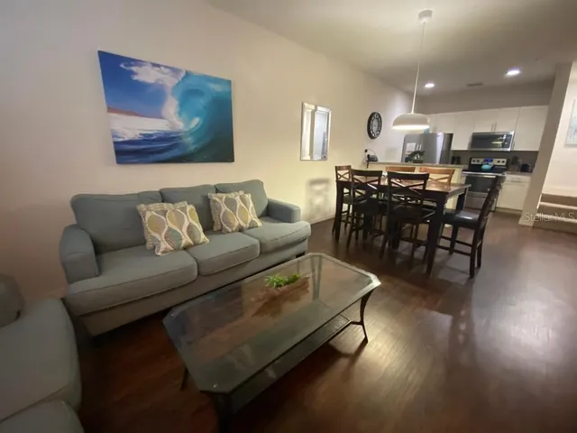 a living room with furniture and wooden floor
