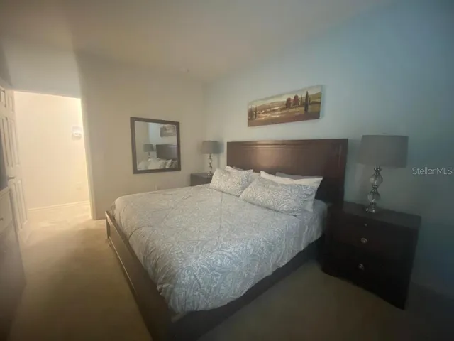 a bed room with a bed and a night stand