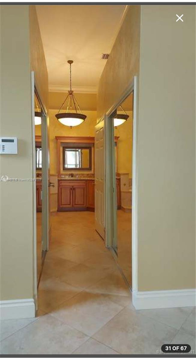 4045 Southwest 151st Terrace Miramar, FL 33027 - Photo 16 of 29 a view of a hallway with wooden floor and a kitchen