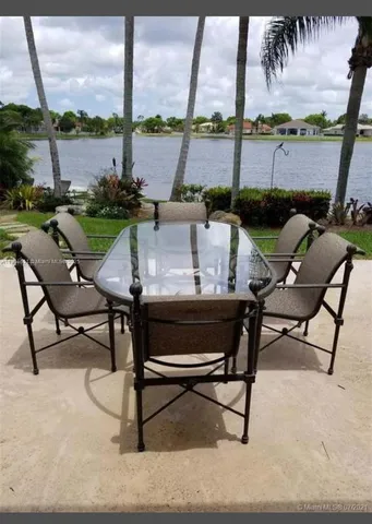 a view of a dining room with a table and chairs