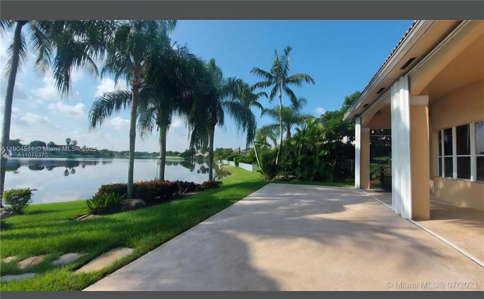 4045 Southwest 151st Terrace Miramar, FL 33027 - Photo 25 of 29 a view of a backyard with plants and lake view