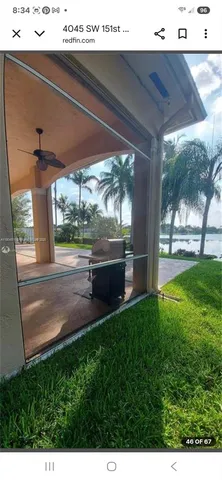 a view of a lake with a house in background