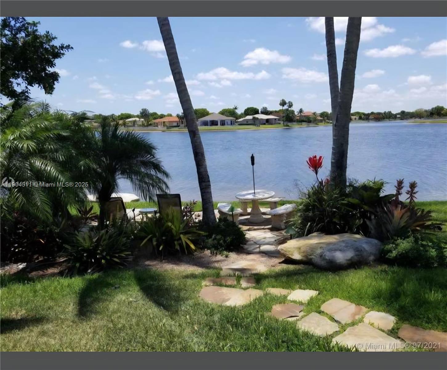 4045 Southwest 151st Terrace Miramar, FL 33027 - Photo 27 of 29 a view of a lake with a house in background