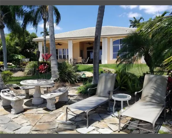 a view of a house with backyard porch and sitting area