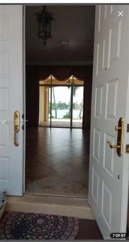 a view of a room with an empty space and window