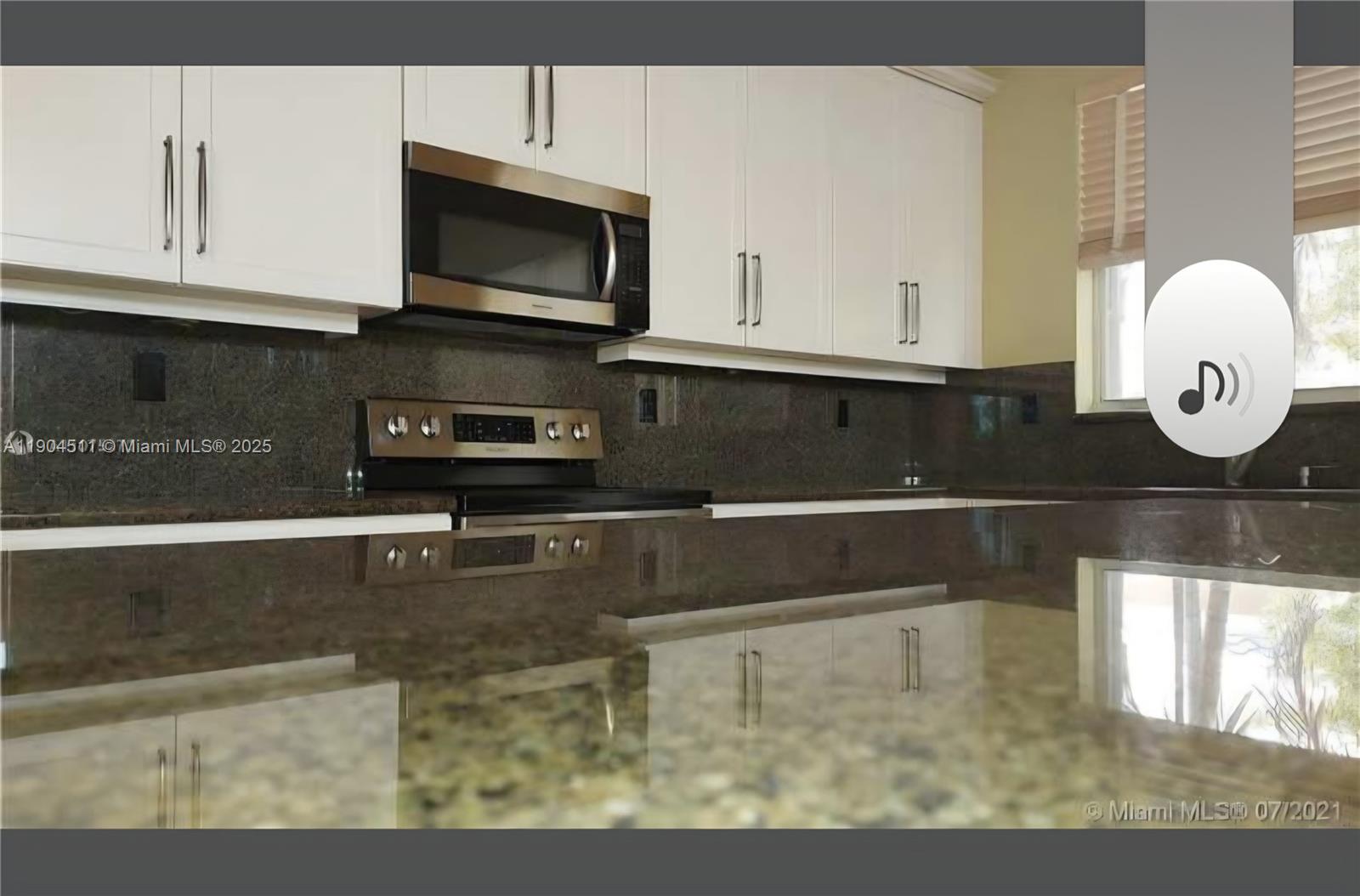 4045 Southwest 151st Terrace Miramar, FL 33027 - Photo 9 of 29 a kitchen with a sink a microwave and cabinets