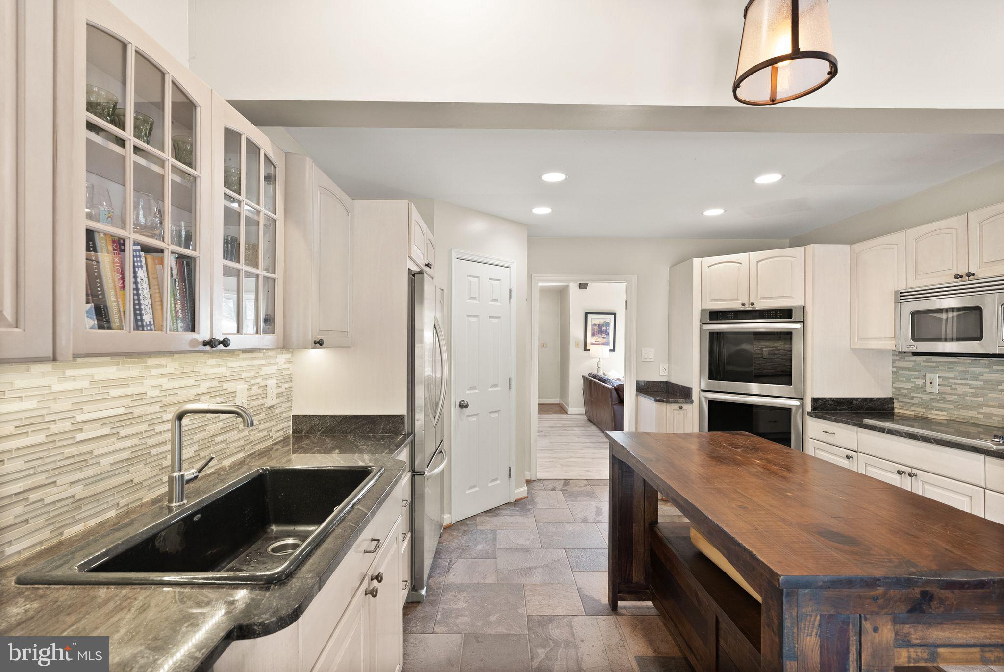 3012 Russell Road Alexandria, VA 22305 - Photo 14 of 56 a kitchen with a sink stainless steel appliances and cabinets