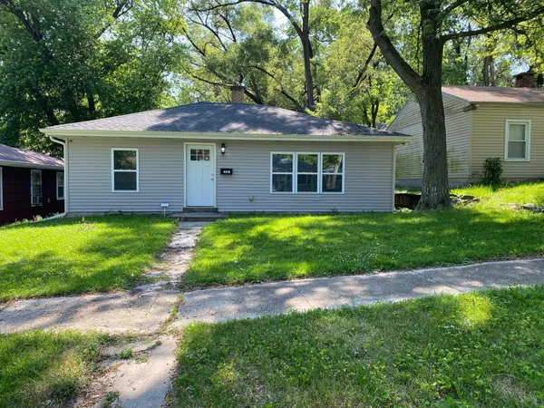 a front view of house with yard and green space