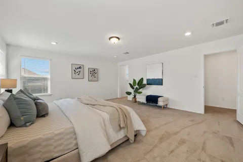 a bedroom with a bed and a couch