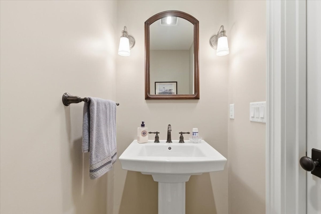 1090 Shore Road, Unit 7 Bourne, MA 02559 - Photo 11 of 42 a bathroom with a sink and mirror