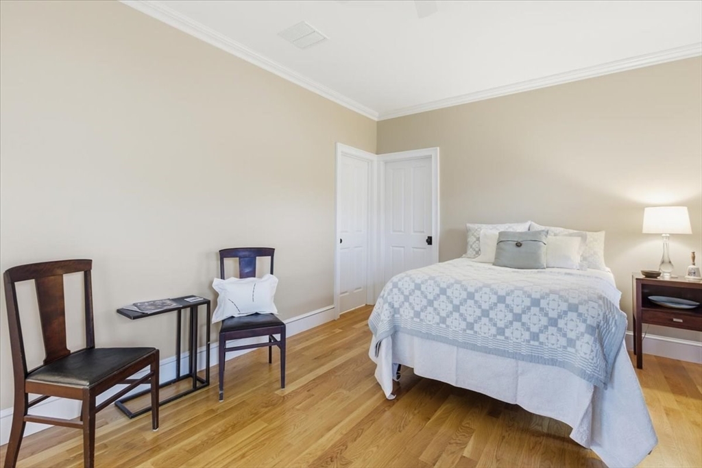 1090 Shore Road, Unit 7 Bourne, MA 02559 - Photo 13 of 42 a bedroom with a bed and a chair