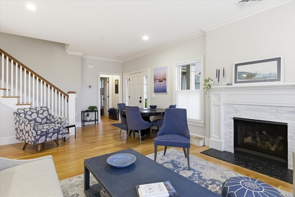 1090 Shore Road, Unit 7 Bourne, MA 02559 - Photo 14 of 42 a living room with furniture a fireplace and a table