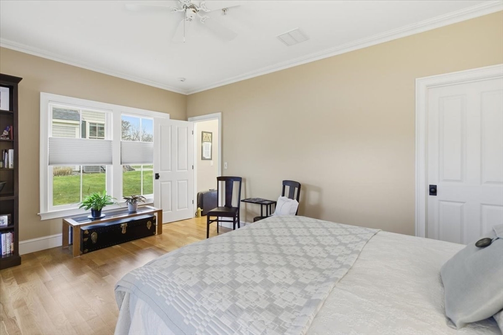 1090 Shore Road, Unit 7 Bourne, MA 02559 - Photo 16 of 42 a bedroom with a bed and large windows