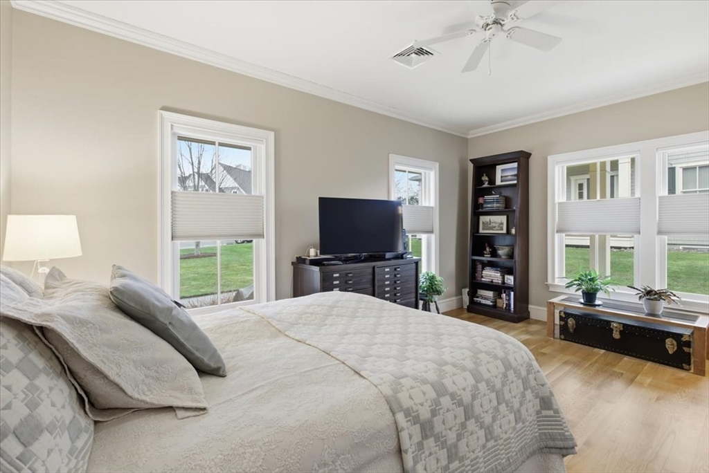 1090 Shore Road, Unit 7 Bourne, MA 02559 - Photo 17 of 42 a bedroom with a bed and a flat screen tv