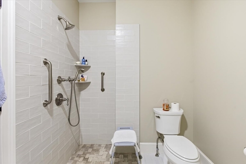 1090 Shore Road, Unit 7 Bourne, MA 02559 - Photo 18 of 42 a white toilet sitting next to a bathroom sink