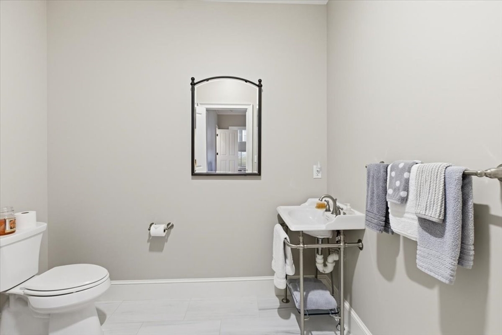 1090 Shore Road, Unit 7 Bourne, MA 02559 - Photo 19 of 42 a bathroom with a toilet sink and mirror