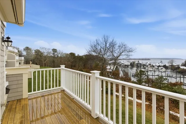 a view of a balcony with wooden floor and fence
